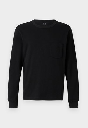 Črna dolgi rokav t-shirt, izdelana iz mehkega bombaža, z okroglim izrezom, rebrastimi manšetami in majhnim žepom na prsih. Minimalističen dizajn.
