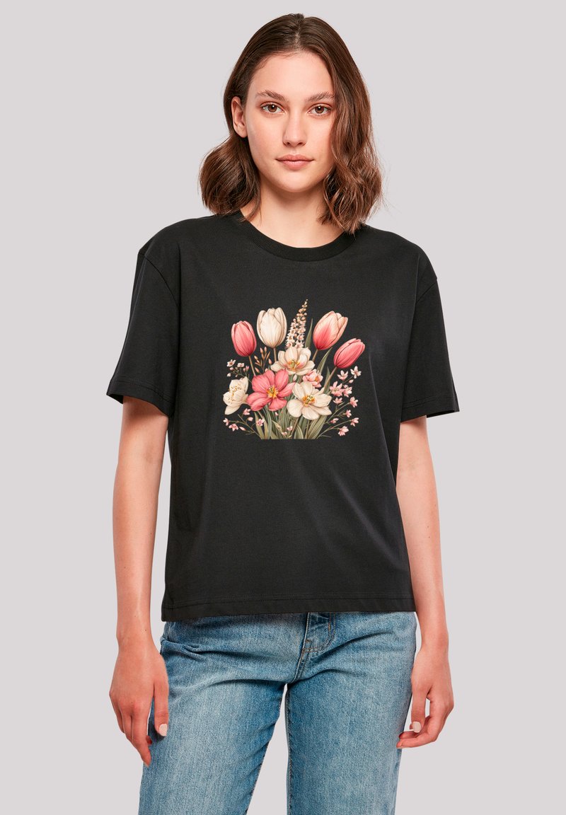 Black cotton t-shirt with short sleeves, featuring a floral print of tulips and blossoms in pink, white, and yellow at the center.