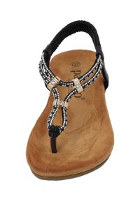 Sandalo infradito nero con dettagli in strass, soletta in suede beige e cinturino elastico nero flessibile. Forma leggermente sagomata per un supporto ottimale.