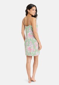 Floral-print nightgown in green with pink flowers, featuring adjustable spaghetti straps and a relaxed fit that falls above the knee.