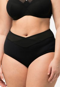 Black high-waisted panties with a textured mesh waistband, featuring a chevron design and smooth fabric.
