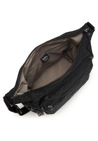 Black fabric handbag with a textured exterior, two zippered compartments, and a smooth beige interior lining. Features a logo patch and adjustable strap.