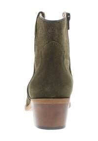 Dark green suede ankle boot with a curved heel, a side zipper, and a wooden base. Smooth texture with stitched detailing on back.