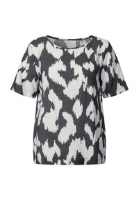 Kortærmet T-shirt i en blanding af sort og hvid; har et mønsterdesign med uregelmæssige former og en rund halsudskæring.