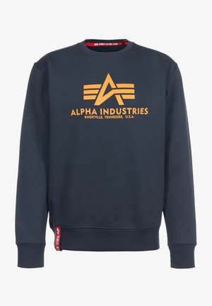 Marineblauer Pullover aus Baumwolle mit einem orangefarbenen Logo und Textdesign. Enthält ein rotes Etikett an der unteren linken Seite. Rundhalsausschnitt.