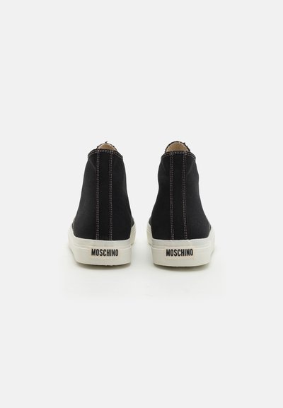 Black canvas high-top sneakers with contrasting pink stitching, white rubber sole, and MOSCHINO logo on the back.