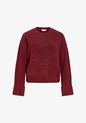 Czerwony dziergany sweter z długimi rękawami, ściągaczami na mankietach i dole. Miękka tekstura, luźny krój oraz klasyczny okrągły dekolt.