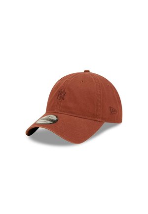 Rust-colored baseball cap made of cotton with a curved brim and embroidered logo on the front. Features ventilation eyelets and textured fabric.