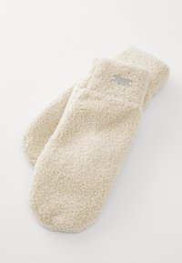 Cream-colored fleece mittens with a textured surface and a silver label accent. Soft, rounded shape for warmth and comfort.