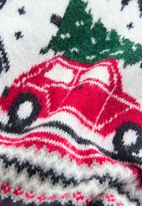 Red and white knit sweater featuring a festive design with a red car, green tree, black accents, and a soft, fuzzy texture.