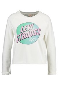 Sudadera blanca de manga larga con un logo redondo en tonos pastel que dice "LEVI STRAUSS & Co" en rosa y verde en el frente. Tejido suave.