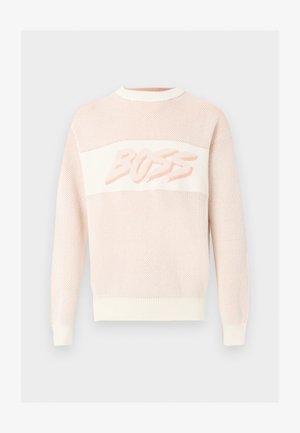 Light pink knit sweater with long sleeves and ribbed cuffs, hem, and collar, featuring the word "BUZZ" across the chest in a stylized font.