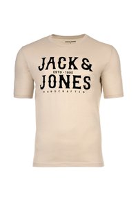 Beige puuvillapaita lyhyillä hihoilla, jossa on voimakas musta graafinen teksti "JACK & JONES HANDCRAFTED."