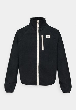 Must must jacket kõrge kraega, ees ultimatu, valged tõmblukukohad ja väike logo läätis vasakus rinnas.