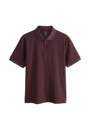 Burgundy polo shirt with short sleeves, textured pattern, zippered collar, and contrasting solid collar and cuff accents.