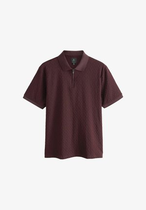 Burgundy polo shirt with short sleeves, textured pattern, zippered collar, and contrasting solid collar and cuff accents.