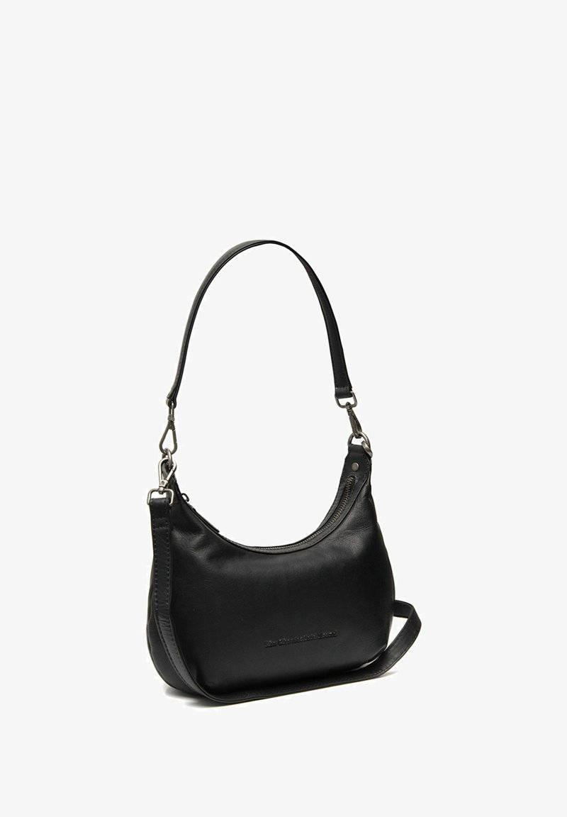 Black leather shoulder bag with a curved silhouette, adjustable strap, silver hardware, and a top zip closure. Features minimal branding detail.