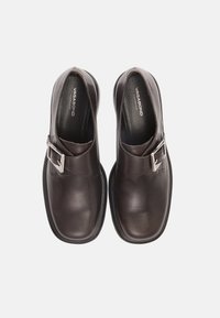 Brown leather shoes with a rounded toe, featuring a side buckle detail, a smooth texture, and a cushioned insole.