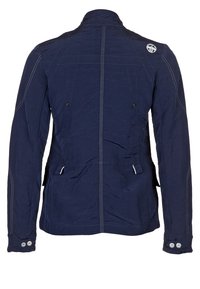 Navy blue jacket made of textured fabric, featuring white stitching, two large buttoned pockets, and a high collar with a logo patch.