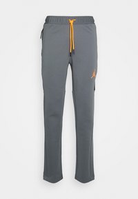 Grå sweatpants i mjukt tyg, med resårmidja och orange snoddar samt en orange logotyp på vänstra låret.
