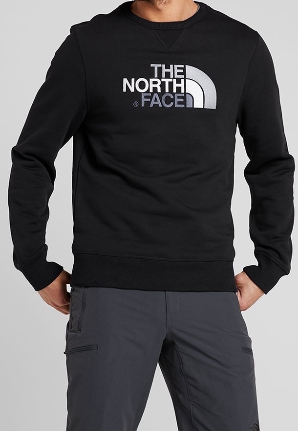 Černá mikina vyrobená z bavlněné směsi. Má kulatý výstřih a žebrované manžety. Na přední straně se nachází velké, kontrastní logo "THE NORTH FACE".