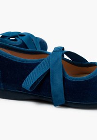 Bailarinas de terciopelo azul con cintas anchas, punta redonda y suave forro interior. Textura suave y suela plana baja para mayor comodidad.