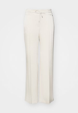 Pantalons larges beige clair avec une taille élastique et un cordon de serrage. Fabriqués à partir d'un tissu texturé avec des plis avant et une coupe décontractée.