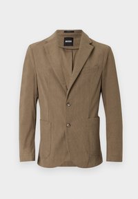 Bruine corduroy blazer met een ingesneden revers, twee voorzakken en twee knopen. Beschikt over een subtiele textuur en een getailleerd ontwerp.