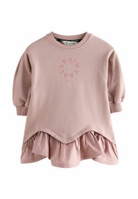 Roze dukserica s volanima na rubu, okruglim izrezom i balonskim rukavima. Ima suptilan okrugli logotip u svjetlijoj roza boji sprijeda.