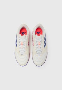 Άσπρα αθλητικά παπούτσια με μπλε ρίγες, υφή διχτυού και κόκκινη επένδυση εσωτε ρικά. Διαθέτουν λευκά κορδόνια και καμπυλωτή σόλα με μπλε λεπτομέρειες.