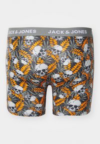 Boxer con elastico in vita, caratterizzati da un tessuto grigio scuro con un motivo di fiori arancioni e teschi grigi su uno sfondo di foglie verdi.