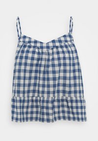 Haut en vichy bleu et blanc avec fines bretelles, un col en V et une taille froncée menant à un bas évasé avec un détail de volants.