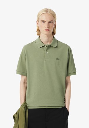 Lichtgroene polo shirt van katoen, met een klassieke kraag, korte mouwen en een klein geborduurd logo op de borst.
