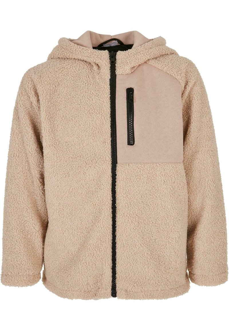 Fleecejacke in Hellbeige mit strukturierter Oberfläche. Verfügt über eine mit Reißverschluss verschlossene Tasche auf der linken Brust und eine Kapuze. Schwarzer Reißverschluss.