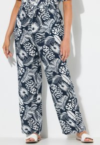 Pantalons à motifs feuillage bleu marine et blanc, dotés d'une taille élastique avec cordon de serrage et d'une coupe ample. Fabriqués en tissu léger.
