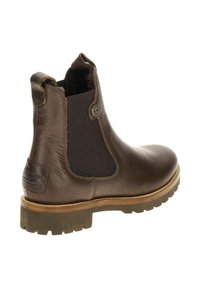 Brązowe skórzane botki typu Chelsea z elastycznymi bocznymi panelami, okrągłym noskiem, teksturowanym wykończeniem i wzorzystą gumową podeszwą zapewniającą przyczepność.