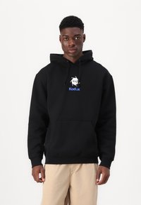 Black hooded sweatshirt with a front pocket, featuring a white and blue "HUF Kodak" logo. The fabric appears soft and textured.