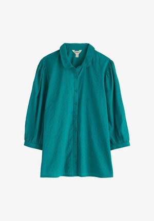 Teal bluza s gumbi in s pufastimi rokavi do tri četrtine ter okroglim ovratnikom, narejena iz teksturirane tkanine.