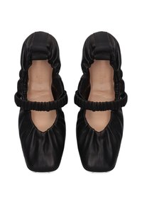 Pair of black ruched leather ballet flats with elastic straps and square toes, viewed from above on a white background.