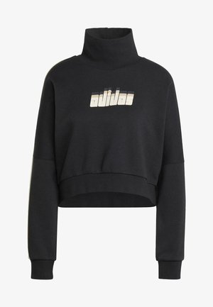 Svart avkortet hettegenser med høy hals, som har et teksturert "adidas"-logo i lyse toner. Mykt materiale og oversized ermer.