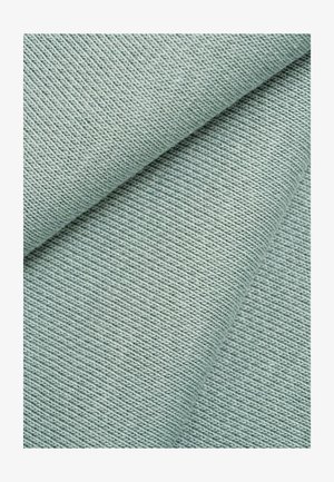 Close-up of folded light blue fabric showing fine ribbed knit texture and diagonal folding lines.