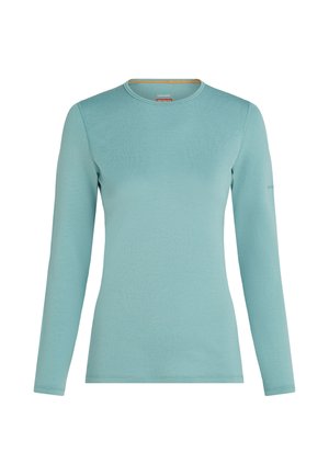 Pitkähihaista pyöreäkaulaista paitaa vaalean teal-värissä, valmistettu sileästä kevyestä kankaasta, etupuoli näkyvissä ompeleet saumoissa.