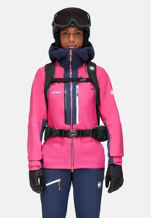 Helle pinke Skijacke mit marineblauen Akzenten, Reißverschluss vorne, Handtaschen und schwarzen Handschuhen. Ausgestattet mit einem Rucksack und einem Helm.