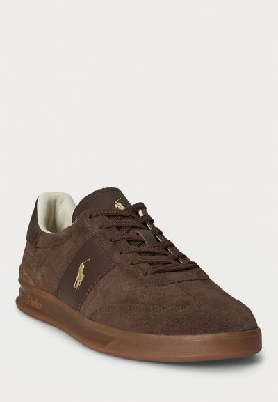 Sneaker in suede marrone con dettagli testurizzati, lacci tono su tono e suola in gomma. Presenta un logo Polo dorato sul lato e un interno imbottito.