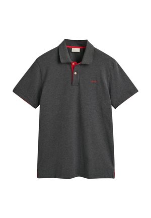 Dark gray polo shirt made from cotton, featuring a contrasting red collar and accents, three buttons, and embroidered logo on the chest.