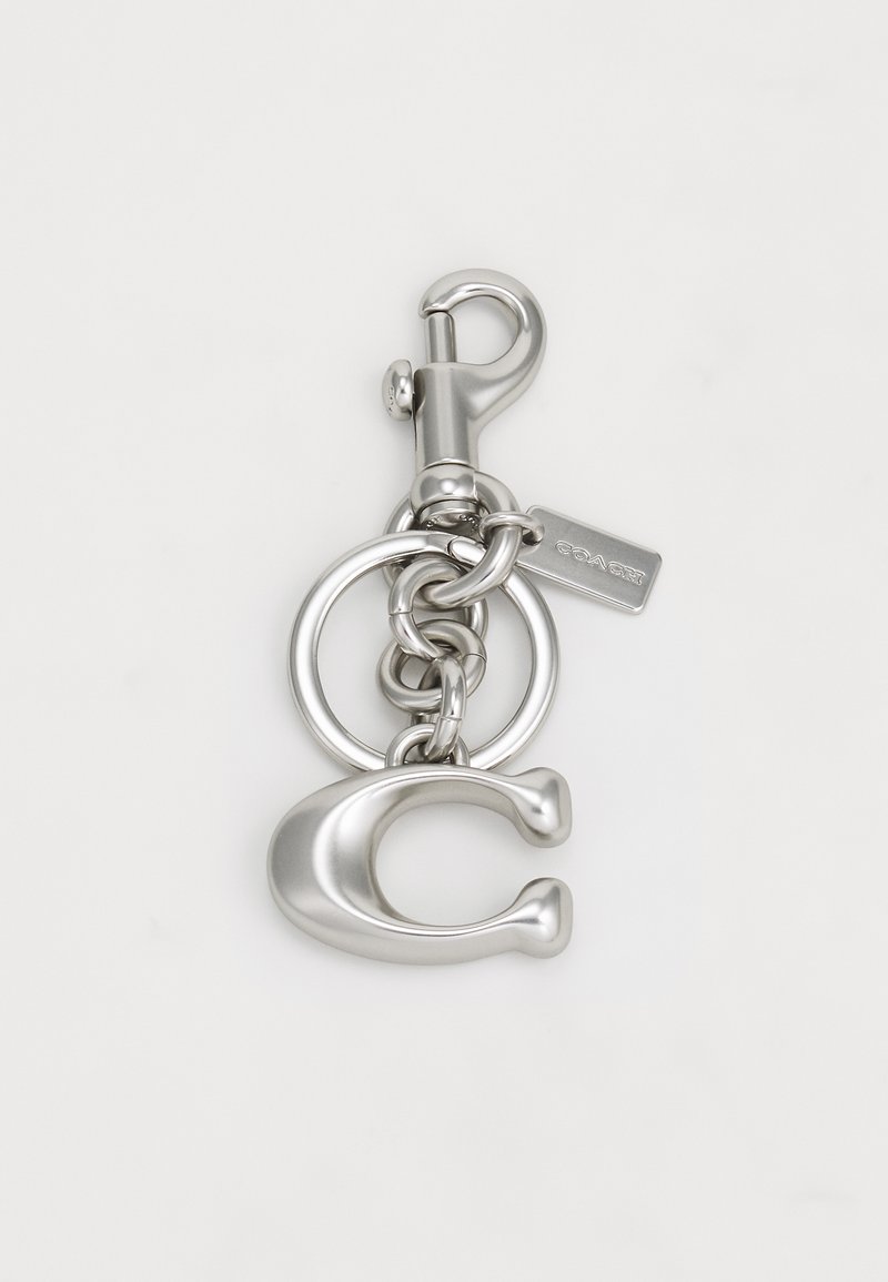 Silver metal keychain featuring a lobster clasp, circular rings, and a stylized "C" charm with a smooth texture.