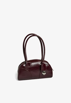 Burgundy handbag with a glossy finish, curved shape, dual handles, and a heart-shaped lock detail. Features stitched panels and zip closure.