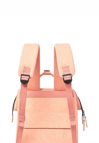 Pink backpack with wide padded straps, textured surface, horizontal seam details, and a side zip pocket. Adjustable hardware accents.