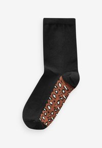 Musta sukka paksulla ruskealla leopardinprintillä, jossa on kermavärisiä pilkkuja, sileä pinta ja klassinen joustavan varren pituus.