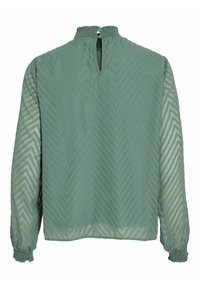 Blusa verde menta con motivo a zigzag testurizzato, maniche lunghe con polsini elasticizzati e una piccola apertura a chiave sul retro.